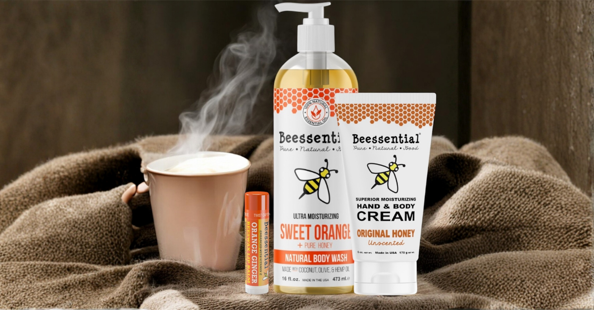Steaming hot cup of tea, Beessential Orange Ginger Lip Balm, Beessential fragrance Free Cream and Beessential Sweet Orange Body Wash