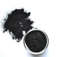 Loose activated charcoal powder used in natural deep-cleansing skincare