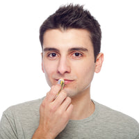 Applying Beessential Lemon Lavender Lip Balm. Vitamin E infused protection for soothing lip care.