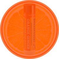 Beessential Orange Ginger Lip Balm tube with a circular graphic highlighting its natural orange ingredients.